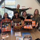 a group of people with boxes of back to school supplies