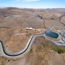 The aerial view looks west toward the the Patterson Reservoir and Patterson Pass-Alameda County Water Plant, located beside the South Bay Aqueduct, part of the California State Water Project in Alameda County. It shows dry land with a snaking canal leading to a reservoir. (Kelly M Grow / California Department of Water Resources)