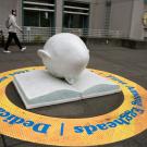 Sculpture of light-blue Egghead by Robert Arneson called Bookhead.