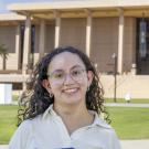 Celine Gomez stands on the lawn in front of the library at CSU, Northridge.