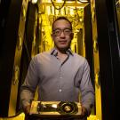 Male scientist holding NVIDIA Titan V graphics card 