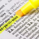 A yellow highlighter goes over the word experience in a dictionary