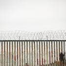 A grayish scene of a border fence