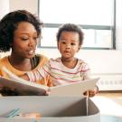 Woman reading a book to small child