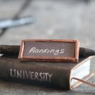 Book that says university with a little sign on top saying rankings