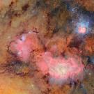 Clouds of yellow and pink scattered with bright white stars