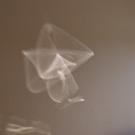 A white geometric pattern on a brown textured wall. 