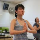 Alison Rader, in the foreground, and Nezrin Hasanly, in the background, are in the yoga prayer position. is in the yoga prayer pose and Nezrin 