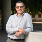 Ross Boulanger leaning against a concrete block outdoors
