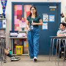 Photo of teacher walking through a classroom