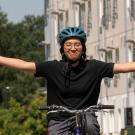Sen Tabofunda rides a bike with her arms outstretched
