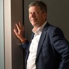 Simon Cherry leans against wall