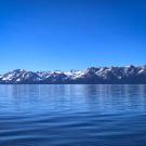 Lake Tahoe's surface in winter with snow-dusted mountains in background