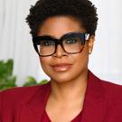 Woman in glasses shown shoulders up