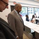 Chancellor Gary S. May looks at student designs for wayfinding signs and other designs for Aggie Square.