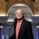 man standing in front of ornate building edifice