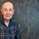 Bruce Hammock stands in front of a chalkboard