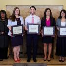 Group photo shows people posing with awards