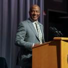 Chancellor Gary S. May, smiling, at lectern