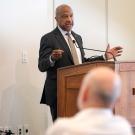 Chancellor Gary S. May speaks, standing at a lectern.