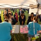 Commencement volunteers assist grads and their guests at a booth. 