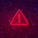 Alert symbol: Red triangle and exclamation point against background of computer code
