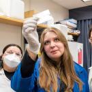 three students looking at a slide