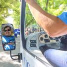 Tram driver as seen in rearview mirror, during parade