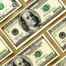 $100-dollar bills on beige background