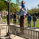 Teacher and students in face coverings, on walking tour, outdoors.
