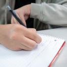 student works on math problem in notebook