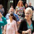 People leave Mrak Hall as firefighters watch.