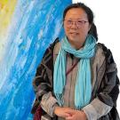 Artist is pictured in front of one of her paintings