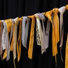 Yellow ribbons are tied to a memorial rope for the ribbon activity, which commemorates deceased loved ones. 