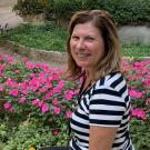 Rita Gibson environmental, seated, flowers in background