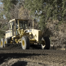 bulldozer rolling over pavement