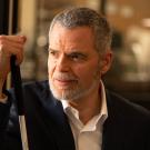 A man holds his can and looks into the distance