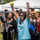 Woman raises arms in victory after dunking the chancellor