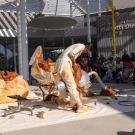 Dancers perform in front of Manetti Shrem Museum, with sign in background