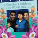 Smiling family posing in floral "Take Our Children to Work Day" event frame