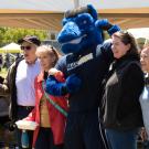 Gunrock flexes as he poses for a photo with four people