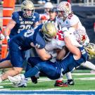 Football player tackles opponent