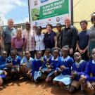 Group of people pose for photo in front of sign that reads "climate smart hydroponics project"