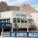 Workers install University Credit Union Center sign at the building’s northeast corner, the main entrance.