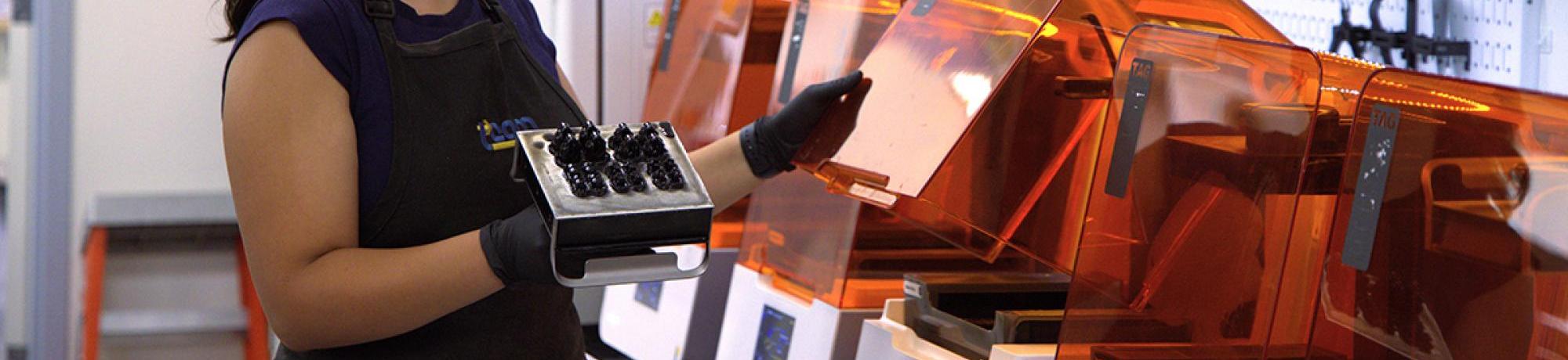 graduate student working on a machine in the engineering lab