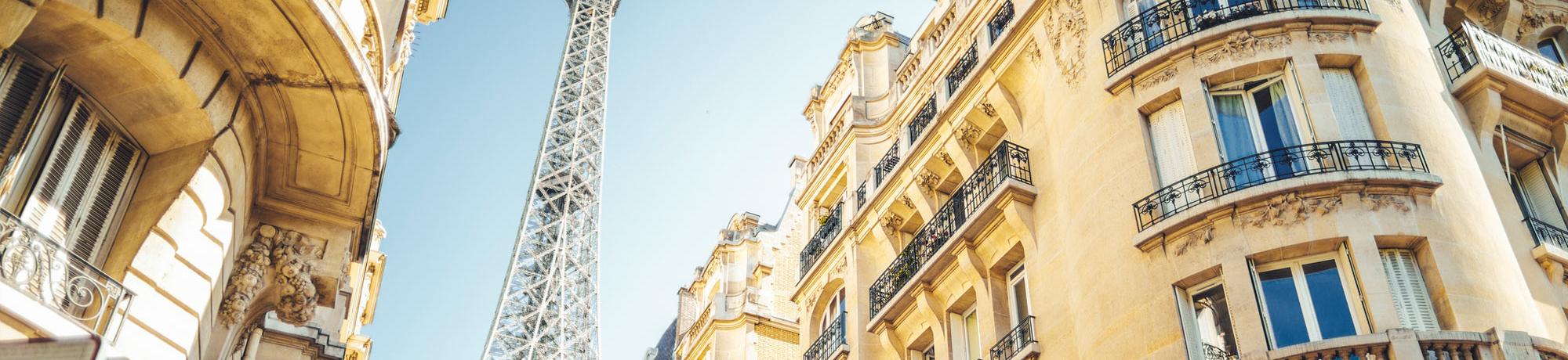 A view of the Eiffel Tower from a Parisian street