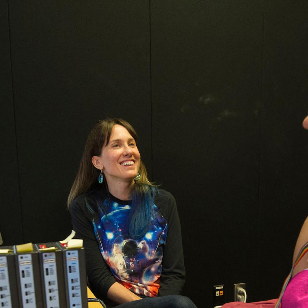 A student has her brainwaves measured by a researcher