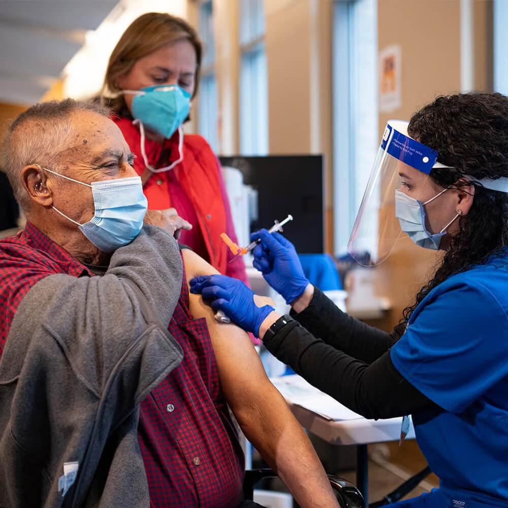 a doctor giving a patient a covid vaccine