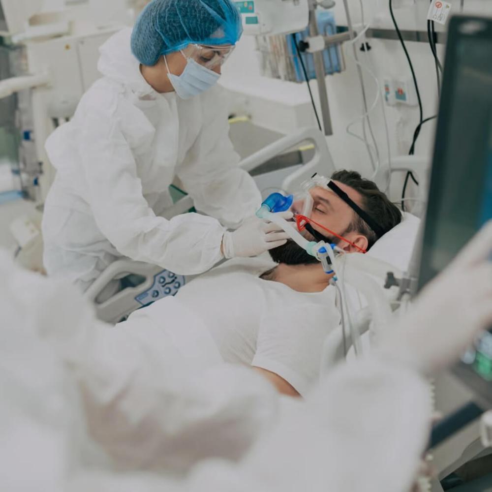 a doctor treating a covid-19 patient