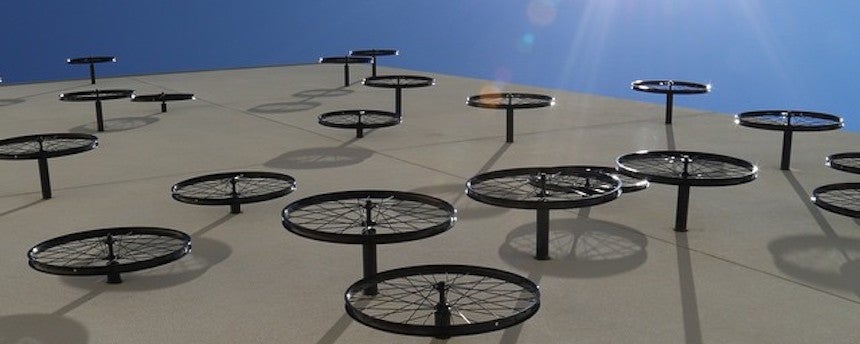 Bike wheels arranged against the side of a building
